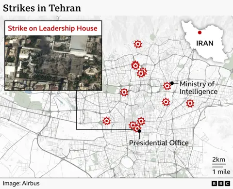 A detailed street‑map of Tehran showing several locations marked with red explosion‑style icons indicating strike sites. In the northern part of the city, one marker sits at the Ministry of Intelligence. Farther south, a cluster of markers indicates multiple strikes near the Presidential Office. To the east, there is another individual strike marker. A box in the upper left shows a satellite close‑up labelled “Strike on Leadership House,” depicting a damaged compound with dark blast marks and surrounding buildings