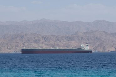 Oil tanker sailing through the Strait of Hormuz amid global oil market tensions