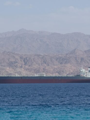 Oil tanker sailing through the Strait of Hormuz amid global oil market tensions